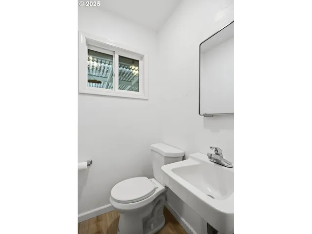 a bathroom with a sink toilet and a mirror