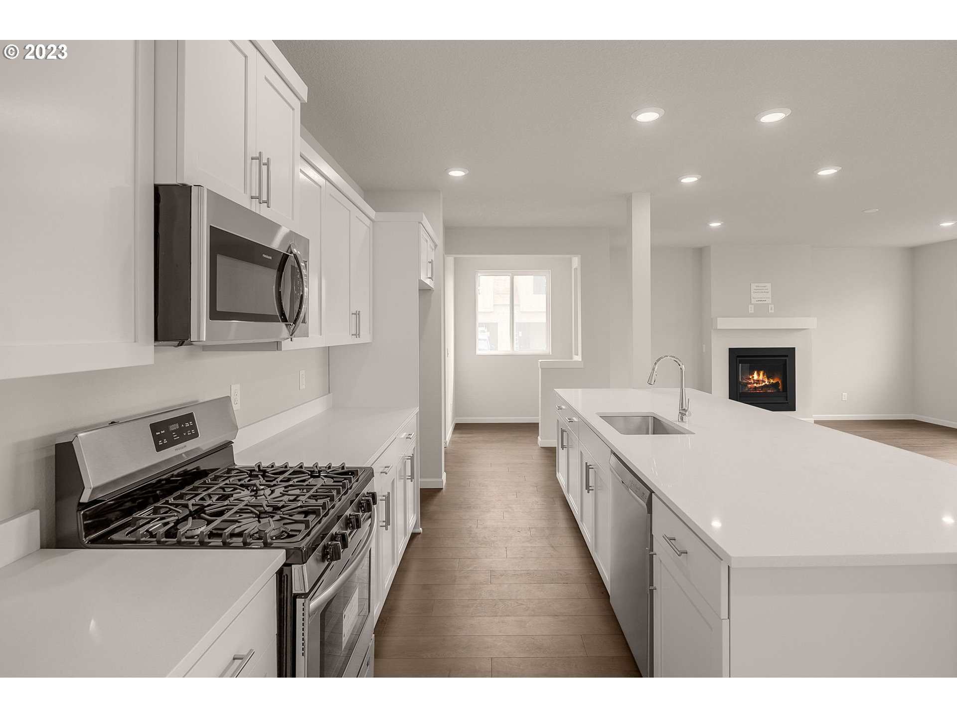 6072 Southeast 24th Street Gresham, OR 97080 - Photo 17 of 37 a large kitchen with stainless steel appliances granite countertop a stove a sink and a microwave