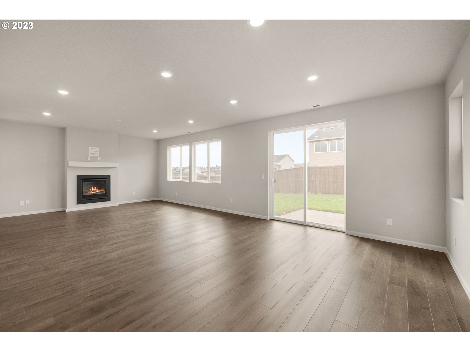 6072 Southeast 24th Street Gresham, OR 97080 - Photo 3 of 37 a view of an empty room with window and wooden floor