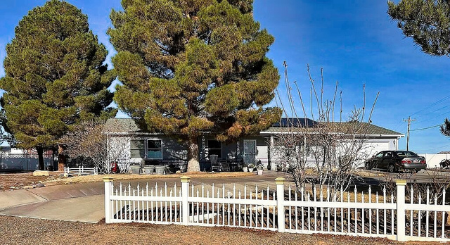 1060 Freedom Way Kanab, UT 84741 - Photo 2 of 12 View of front of home with a fenced front yard and an attached garage