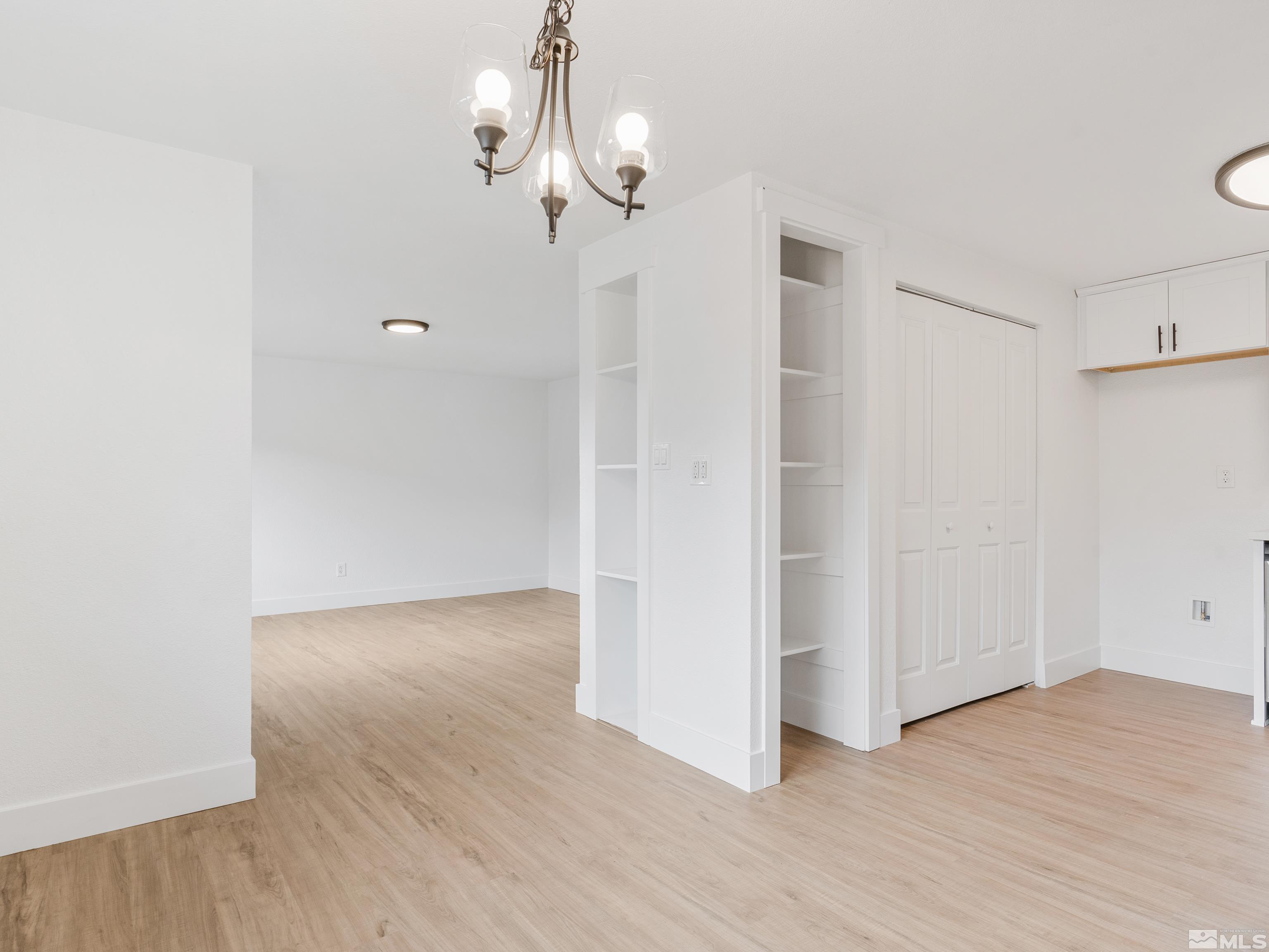 9485 Fremont Way Reno, NV 89506 - Photo 7 of 25 wooden floor in an empty room with a window