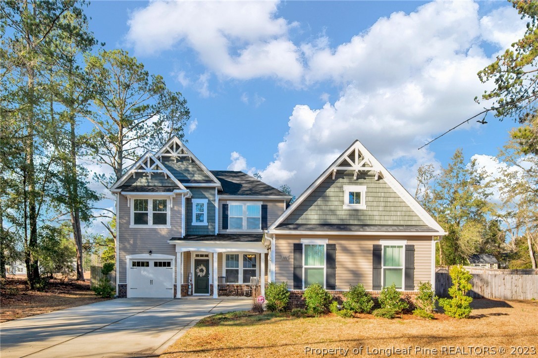 101 Carousel Street West End, NC 27376 - Photo 1 of 50 a front view of a house with a garden