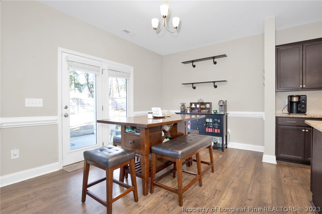 101 Carousel Street West End, NC 27376 - Photo 12 of 50 a view of a dining room with furniture and wooden floor