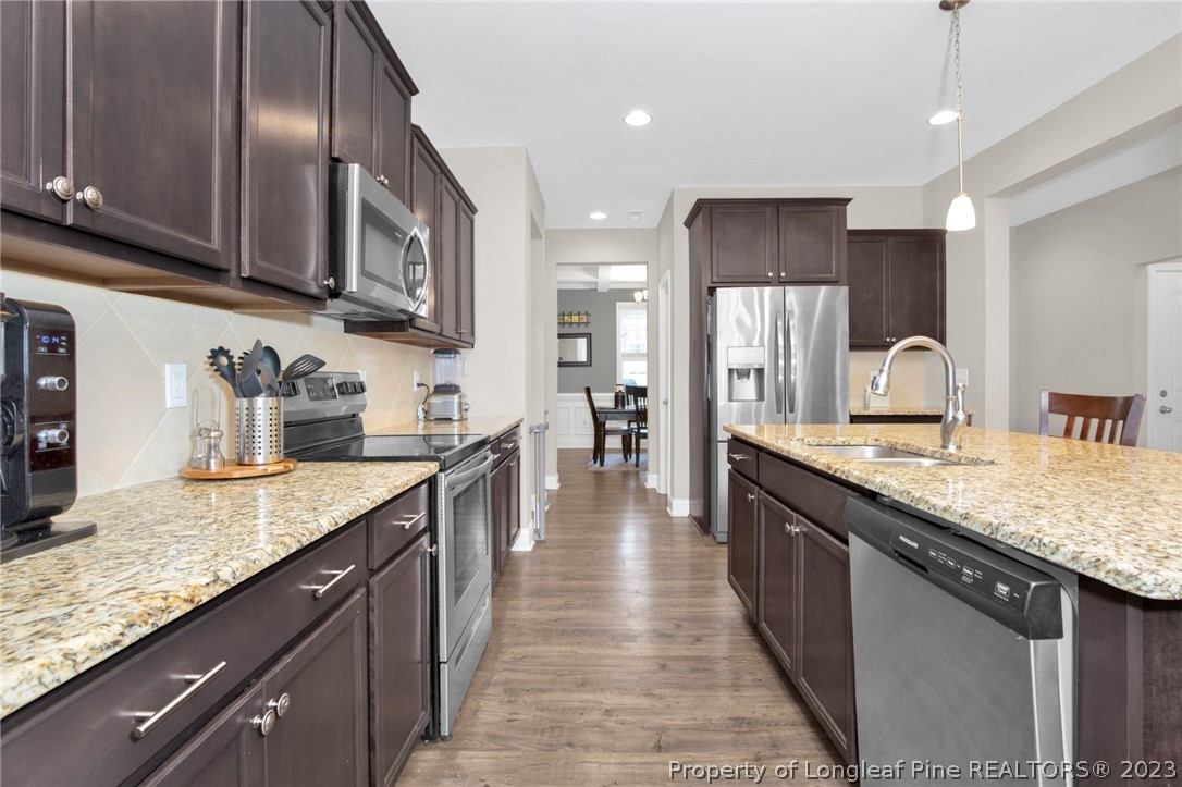101 Carousel Street West End, NC 27376 - Photo 15 of 50 a large kitchen with stainless steel appliances granite countertop plenty wooden cabinets