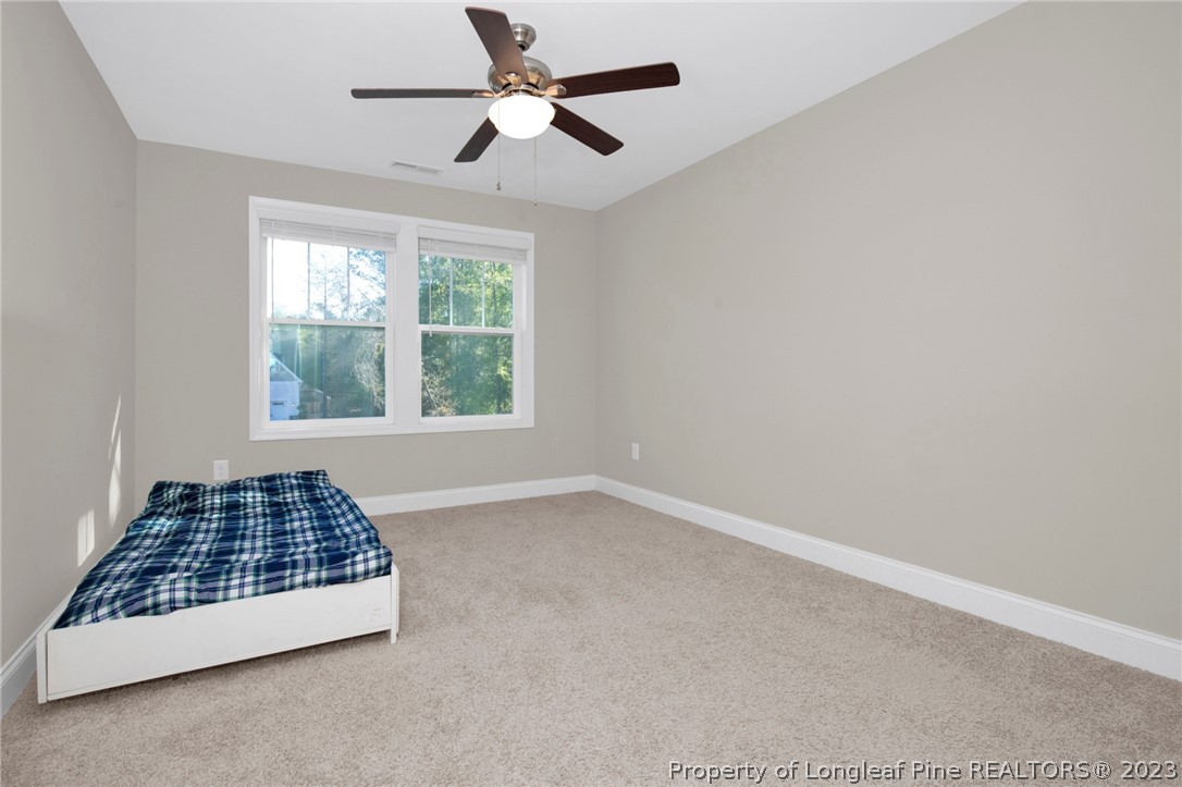 101 Carousel Street West End, NC 27376 - Photo 18 of 50 an empty room with windows and ceiling fan