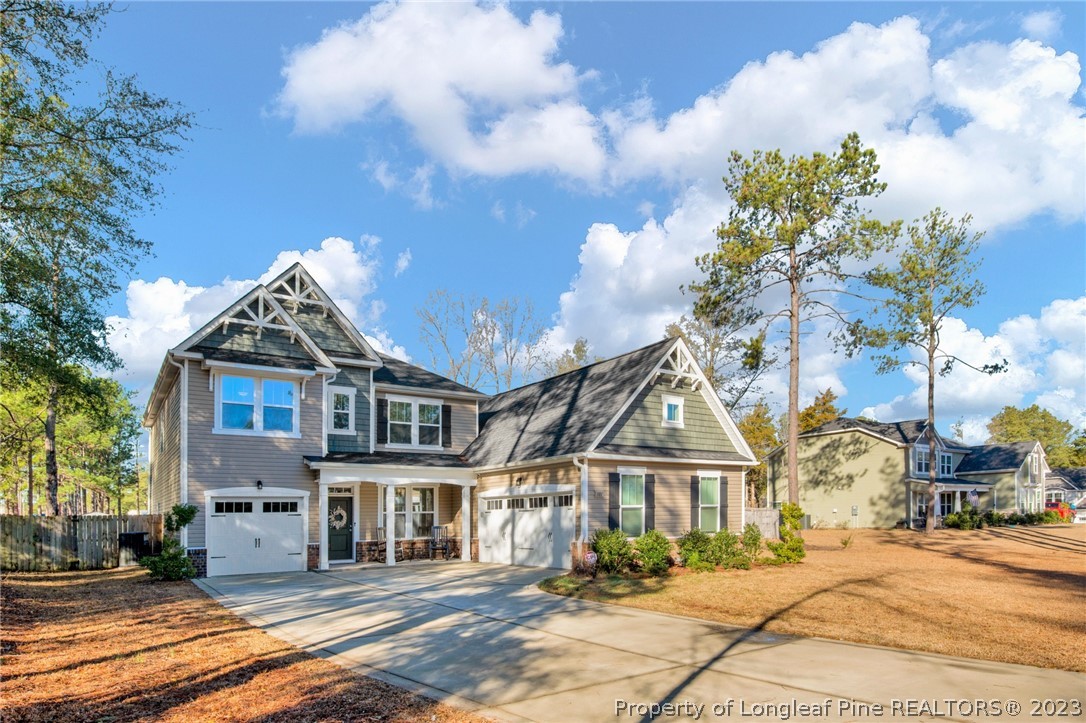 101 Carousel Street West End, NC 27376 - Photo 2 of 50 a view of a big house with a big yard and large trees