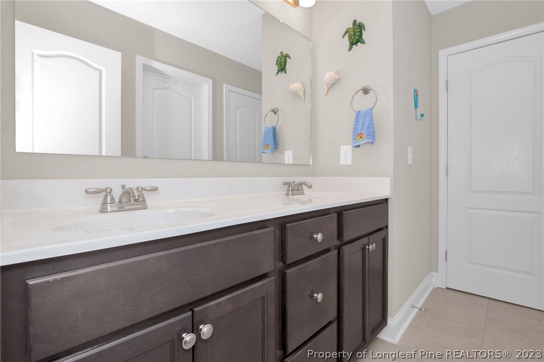 101 Carousel Street West End, NC 27376 - Photo 22 of 50 a bathroom with a sink vanity and a mirror
