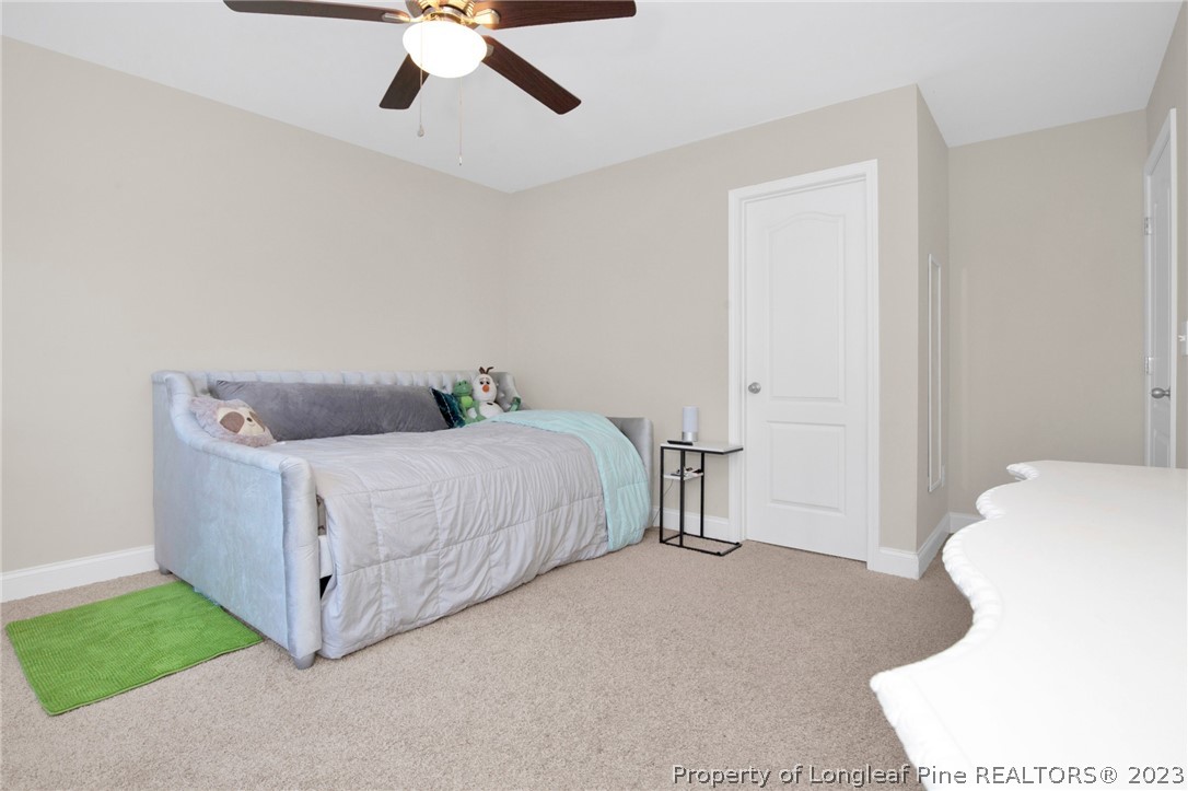 101 Carousel Street West End, NC 27376 - Photo 25 of 50 a bedroom with a bed and a chandelier