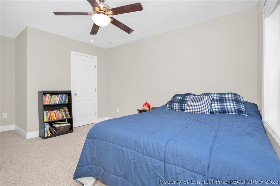 101 Carousel Street West End, NC 27376 - Photo 27 of 50 a bedroom with a bed closet and a window