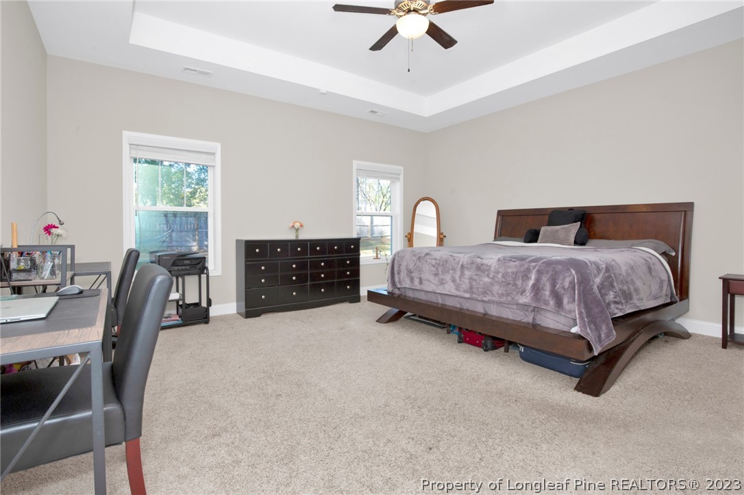 101 Carousel Street West End, NC 27376 - Photo 29 of 50 a living room with a bed furniture a chandelier and a window