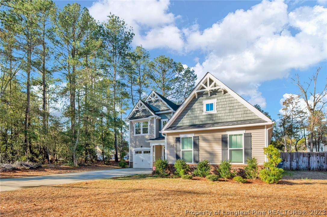 101 Carousel Street West End, NC 27376 - Photo 3 of 50 a front view of a house with a garden