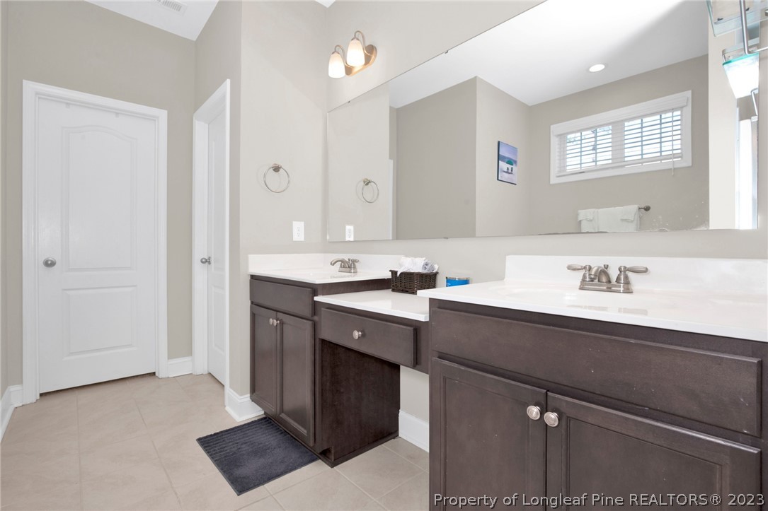 101 Carousel Street West End, NC 27376 - Photo 31 of 50 a bathroom with a sink double vanity and a mirror