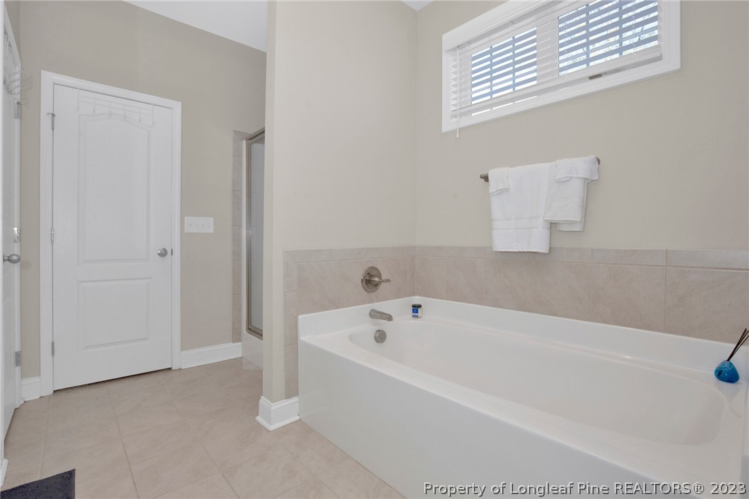 101 Carousel Street West End, NC 27376 - Photo 32 of 50 a white bath tub sitting in a bathroom