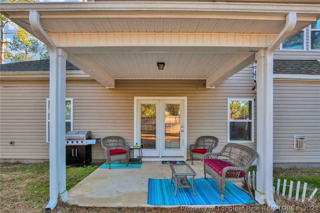 101 Carousel Street West End, NC 27376 - Photo 35 of 50 a view of a porch with furniture and floor to ceiling window
