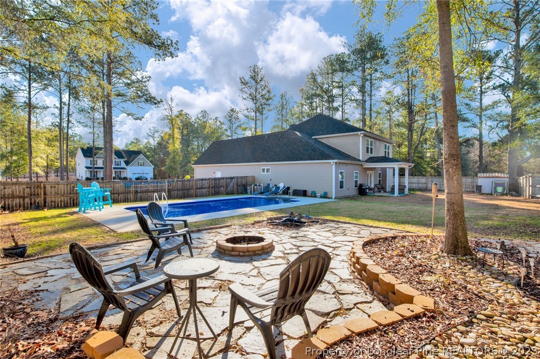101 Carousel Street West End, NC 27376 - Photo 43 of 50 a swimming pool with outdoor seating and yard