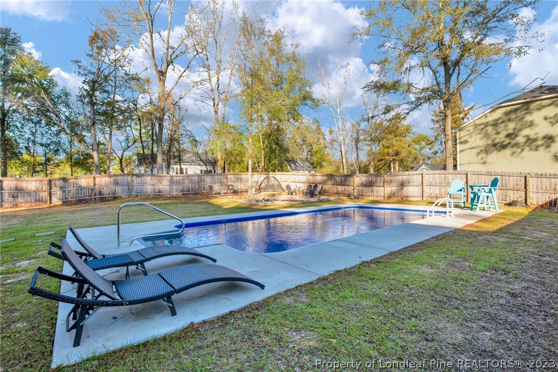 101 Carousel Street West End, NC 27376 - Photo 45 of 50 a swimming pool with outdoor seating and yard