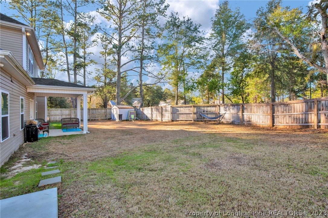 101 Carousel Street West End, NC 27376 - Photo 46 of 50 a view of a yard with a large tree