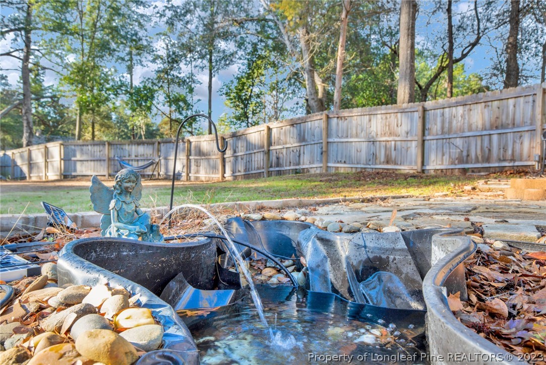 101 Carousel Street West End, NC 27376 - Photo 50 of 50 a view of swimming pool with lawn chairs and wooden fence