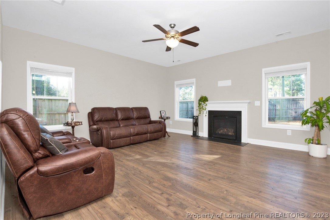101 Carousel Street West End, NC 27376 - Photo 9 of 50 a living room with furniture a fireplace and a window