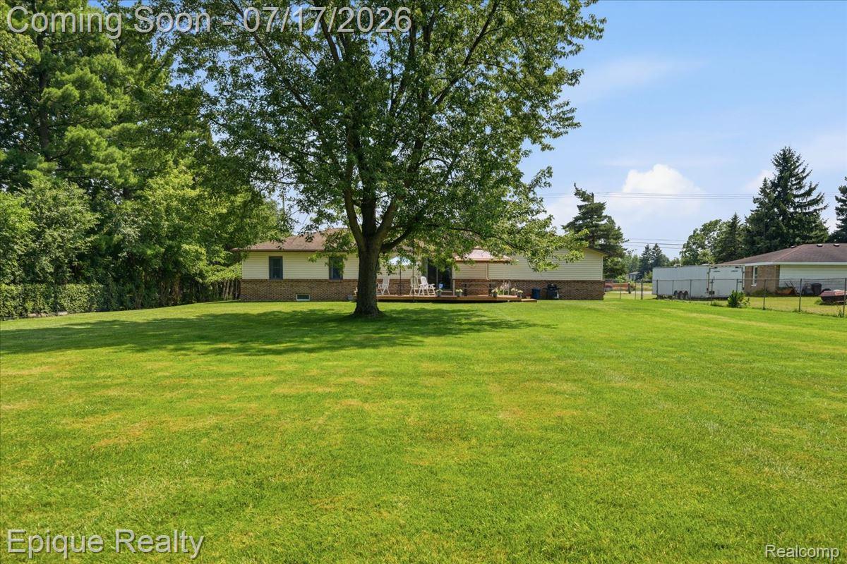 555 East Square Lake Road Troy, MI 48085 - Photo 39 of 48 Expansive green lawn with mature trees