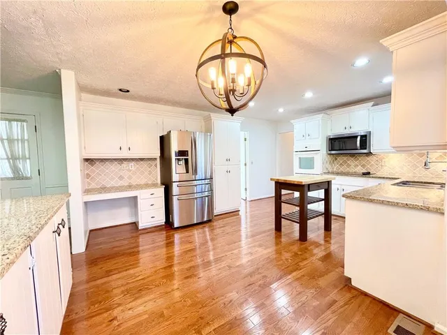 a view of kitchen with cabinets and wooden floor