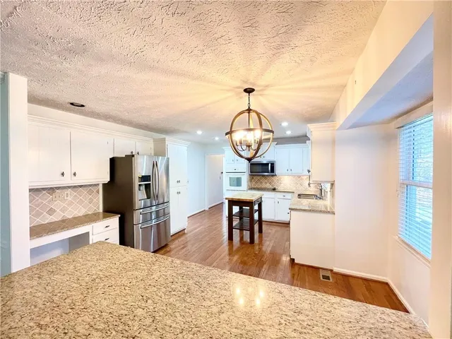 a living room with dining table and wooden floor