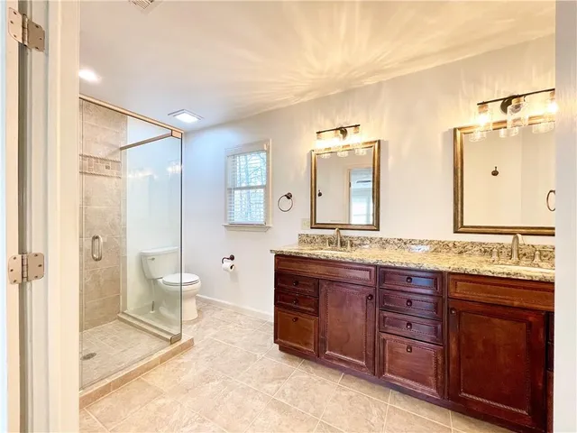 a spacious bathroom with a granite countertop sink mirror and a
