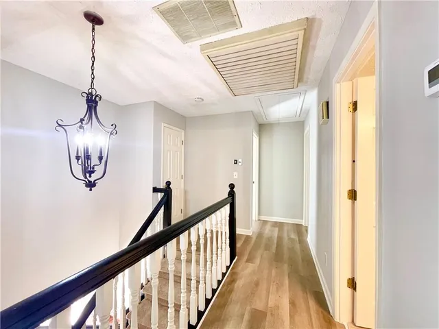 a view of a hallway view with wooden floor and staircase
