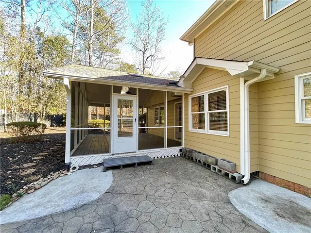 a view of a house with a door and wooden walls