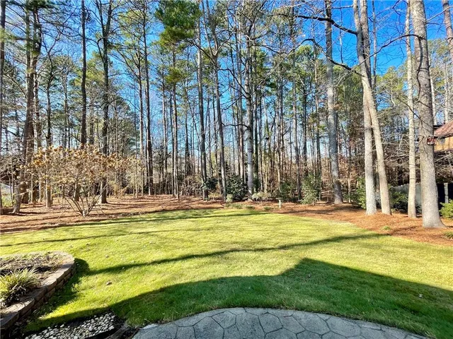 a view of a swimming pool with an outdoor space and seating area