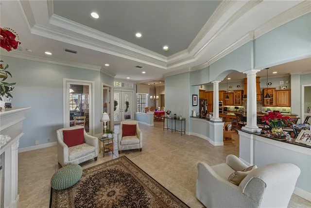 a kitchen with stainless steel appliances kitchen island granite countertop a table chairs and a refrigerator