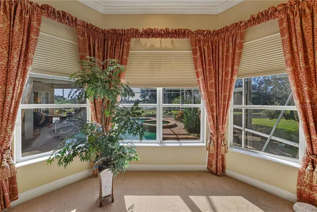 a view of a balcony with chairs and iron fence
