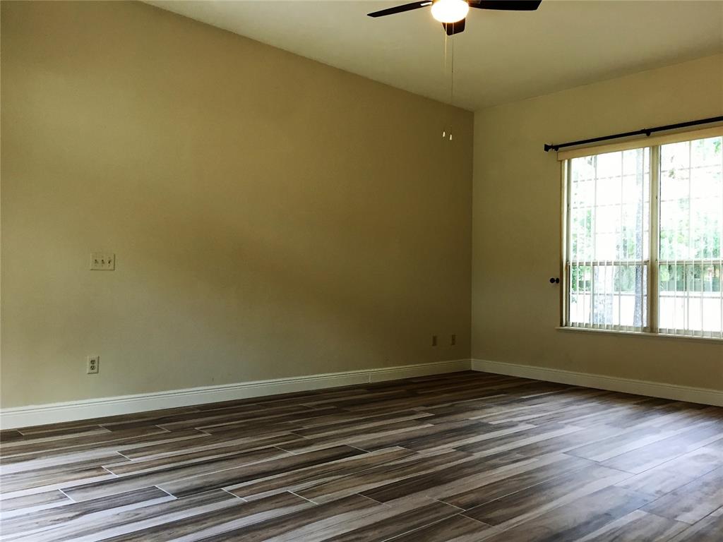 4414 Southwest 91st Drive Gainesville, FL 32608 - Photo 11 of 19 a view of room with window and wooden floor