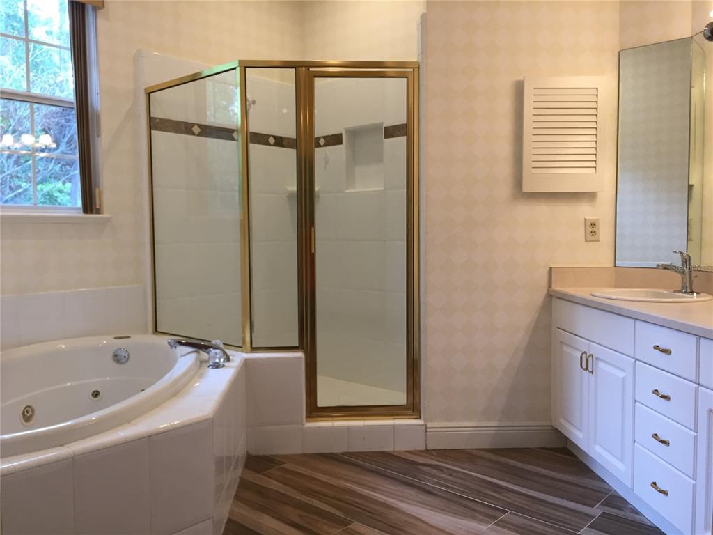 4414 Southwest 91st Drive Gainesville, FL 32608 - Photo 13 of 19 a bathroom with a bathtub and shower