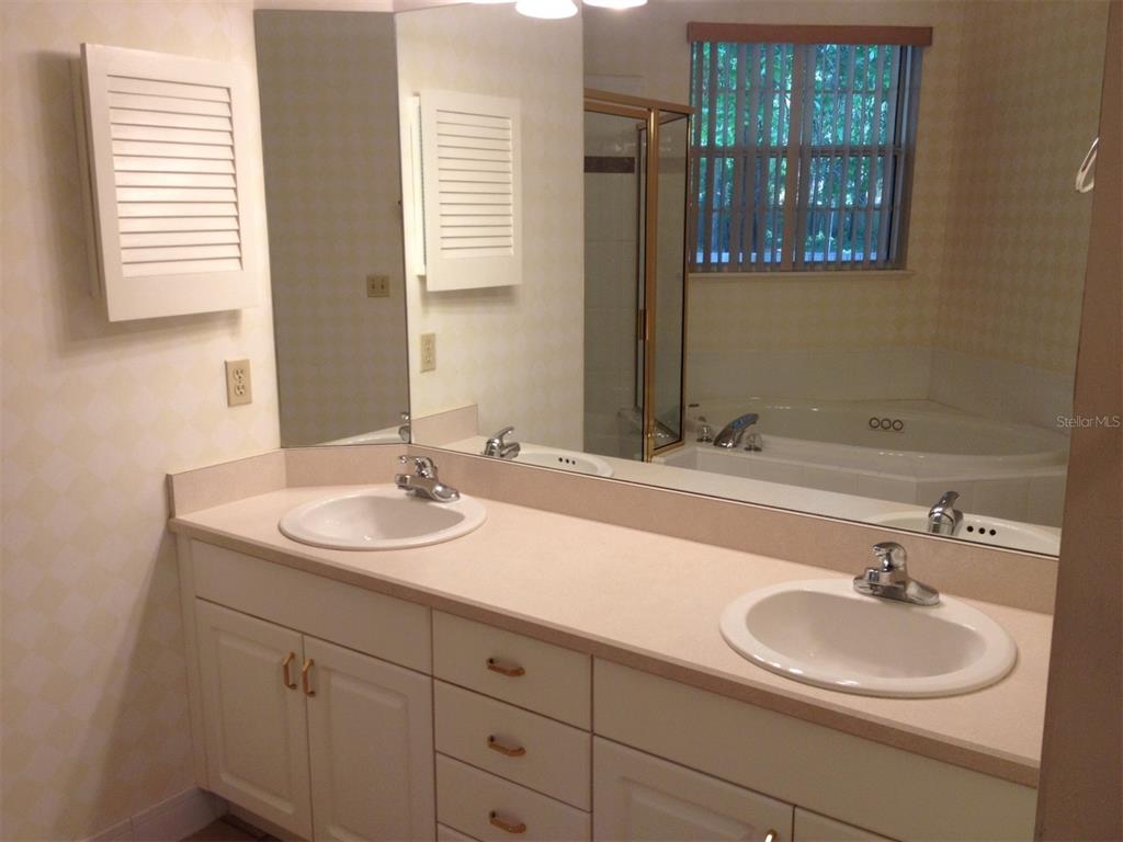 4414 Southwest 91st Drive Gainesville, FL 32608 - Photo 14 of 19 a bathroom with a sink and a mirror