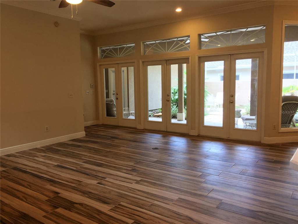 4414 Southwest 91st Drive Gainesville, FL 32608 - Photo 3 of 19 wooden floor in an empty room with a window