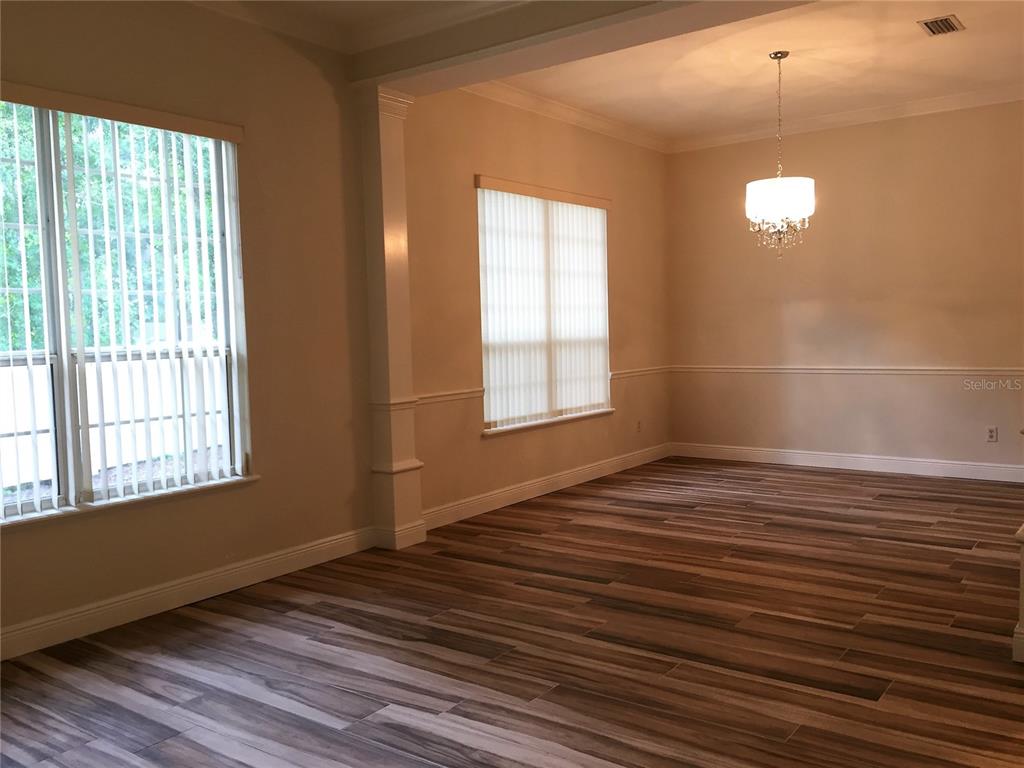 4414 Southwest 91st Drive Gainesville, FL 32608 - Photo 9 of 19 a view of an empty room with wooden floor and a window
