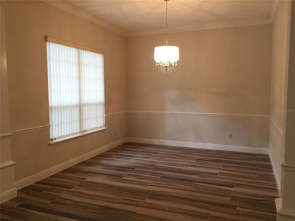 4414 Southwest 91st Drive Gainesville, FL 32608 - Photo 10 of 19 an empty room with wooden floor and windows