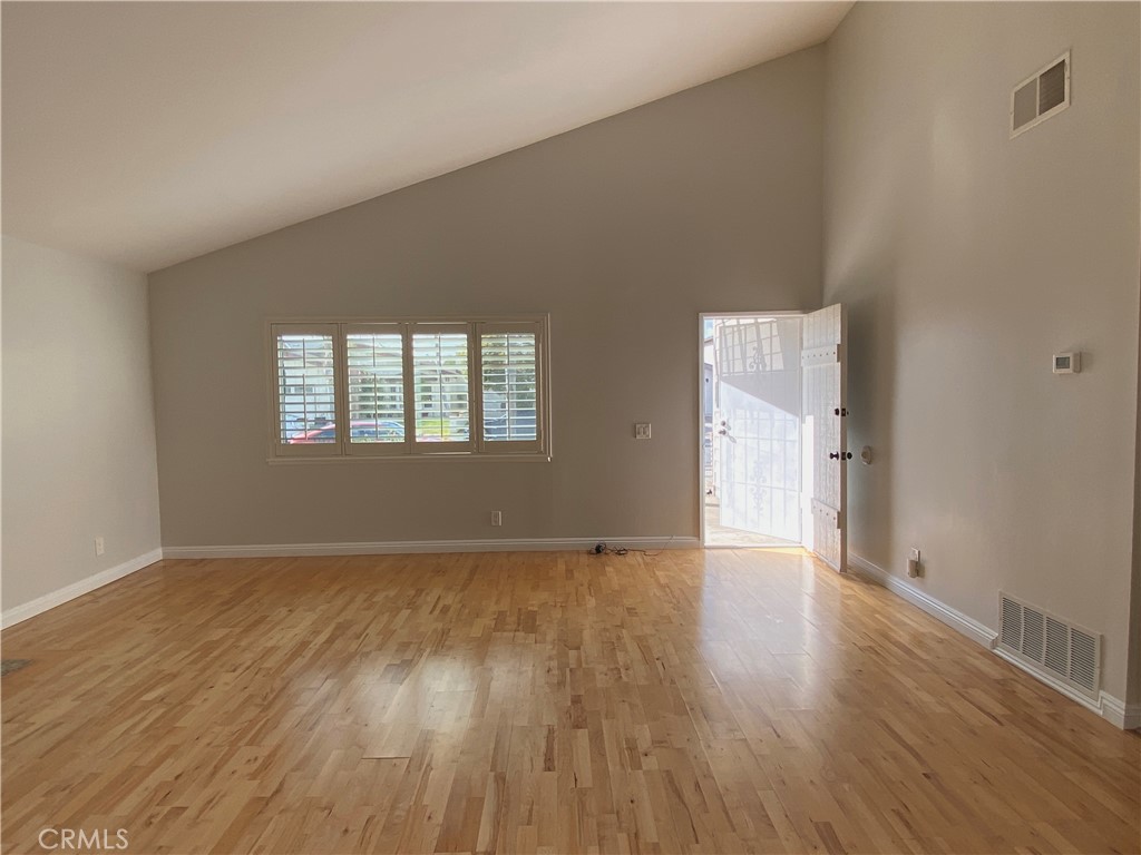 11598 Wake Circle Cypress, CA 90630 - Photo 5 of 20 a view of an empty room with wooden floor and a window