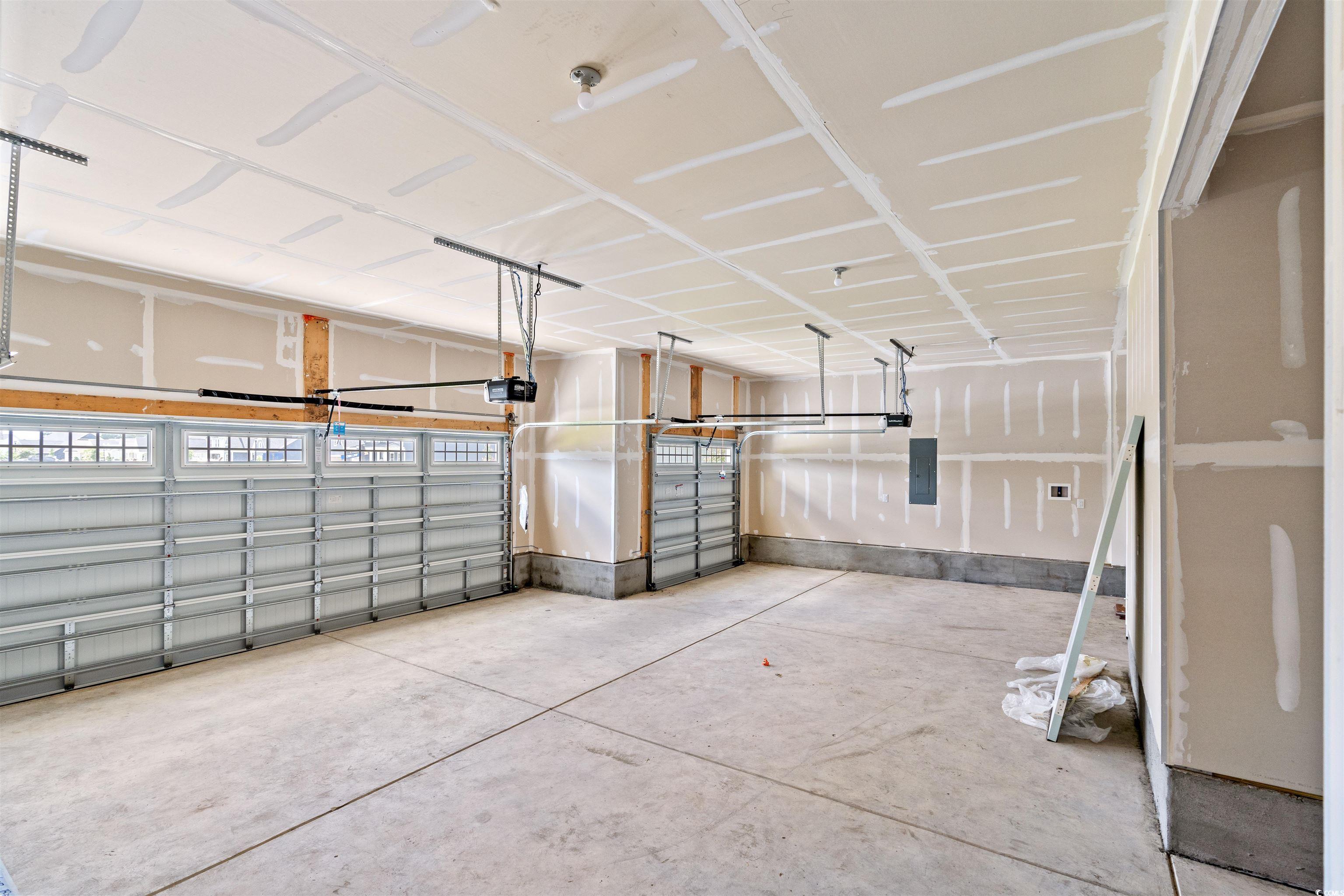7076 Denim Loop Myrtle Beach, SC 29579 - Photo 24 of 27 Garage featuring a garage door opener and electric panel