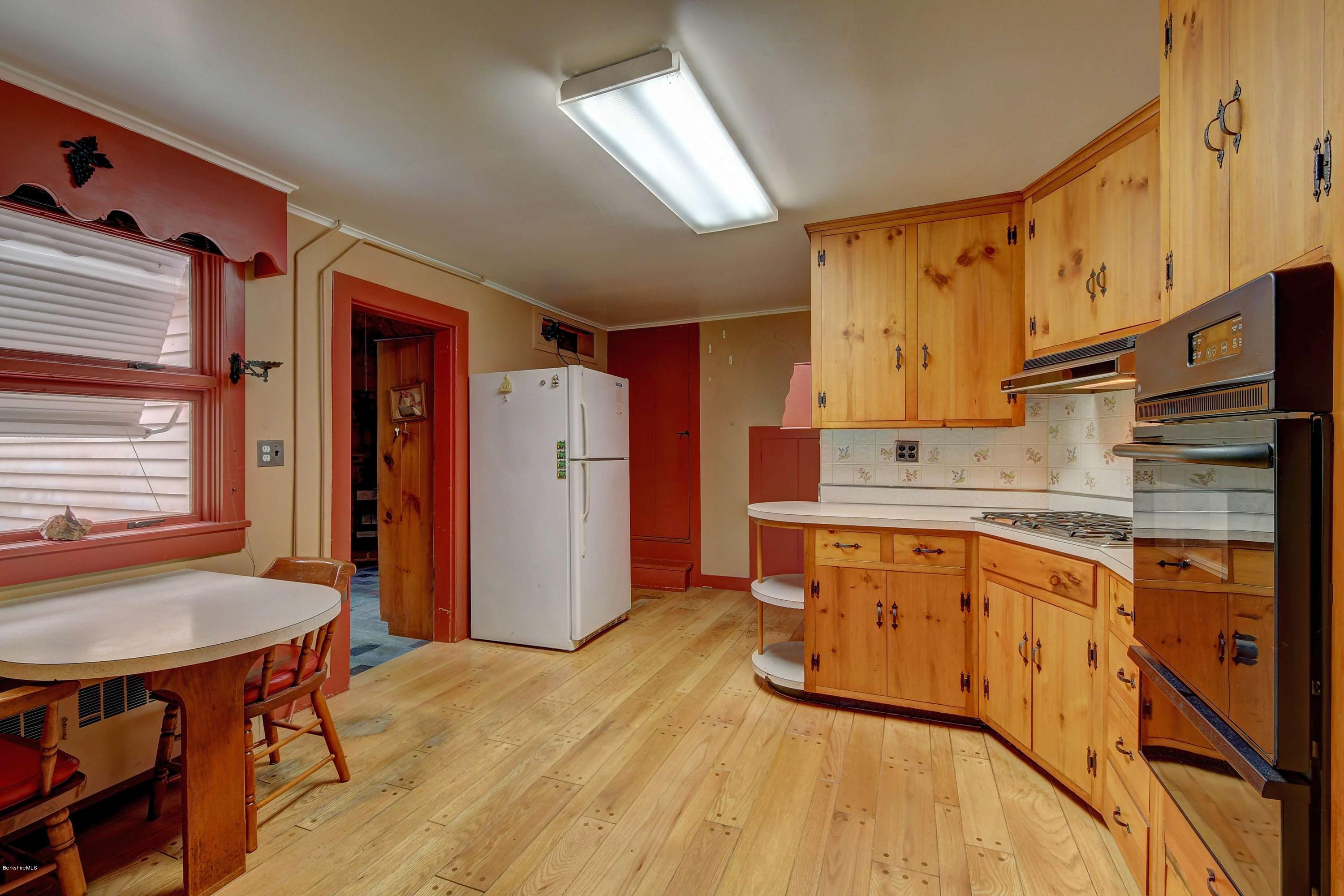 1114 Ashley Falls Road Sheffield, MA 01222 - Photo 11 of 53 a kitchen with stainless steel appliances granite countertop a refrigerator a sink dishwasher and wooden cabinets with wooden floor