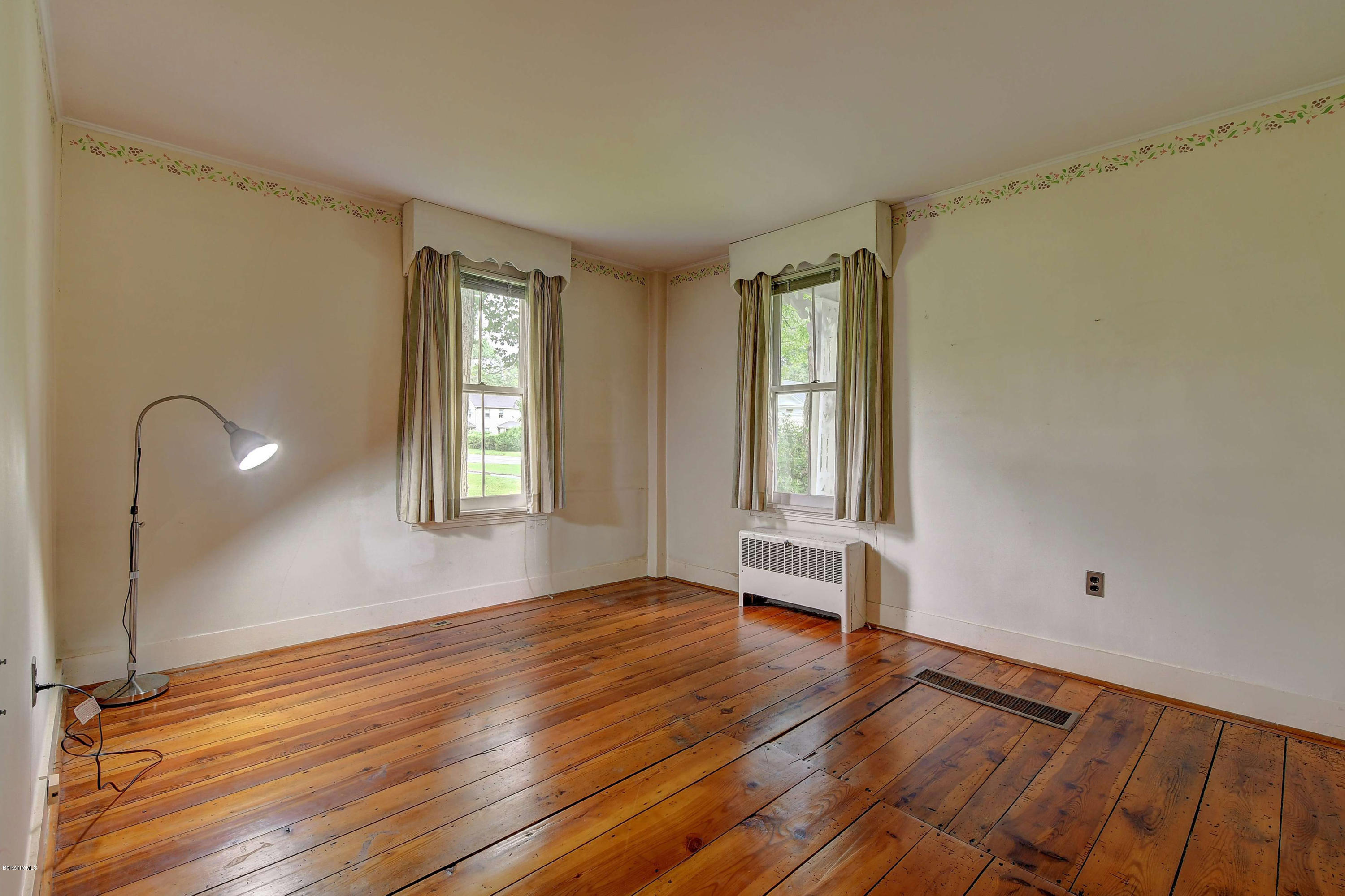 1114 Ashley Falls Road Sheffield, MA 01222 - Photo 20 of 53 a view of an empty room with wooden floor and a window