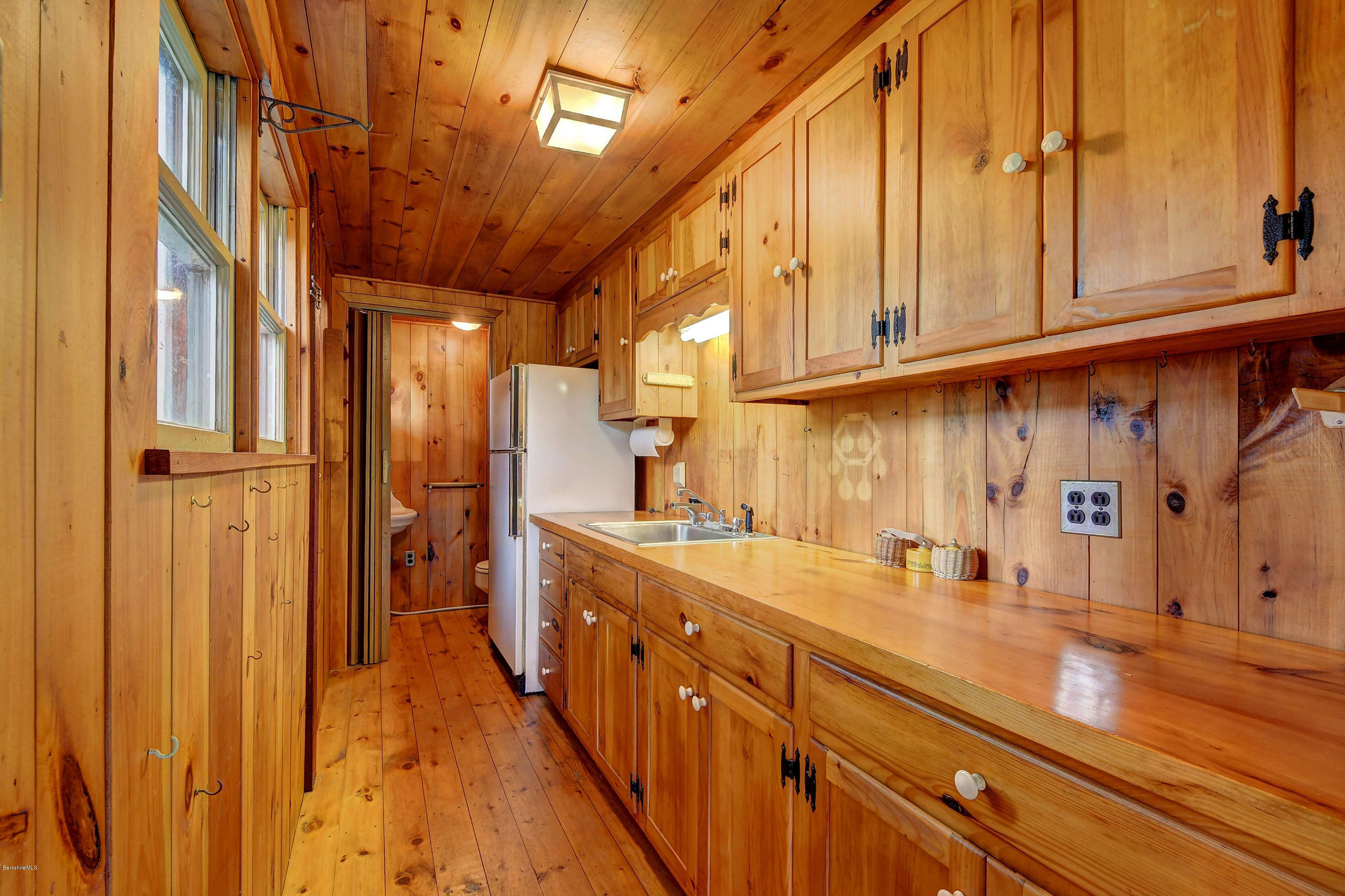 1114 Ashley Falls Road Sheffield, MA 01222 - Photo 42 of 53 a kitchen with stainless steel appliances granite countertop a sink and cabinets