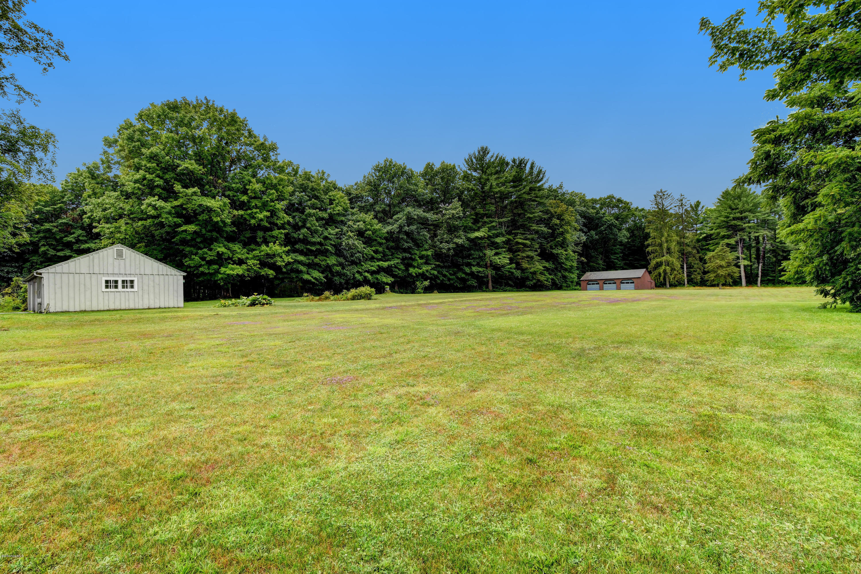 1114 Ashley Falls Road Sheffield, MA 01222 - Photo 49 of 53 a view of a field with trees in the background