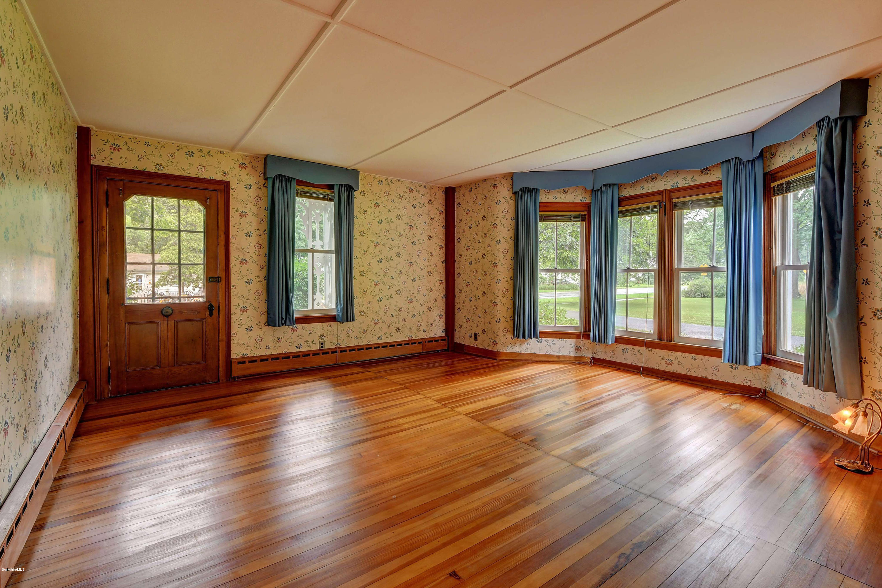 1114 Ashley Falls Road Sheffield, MA 01222 - Photo 7 of 53 a view of an empty room with wooden floor and a window