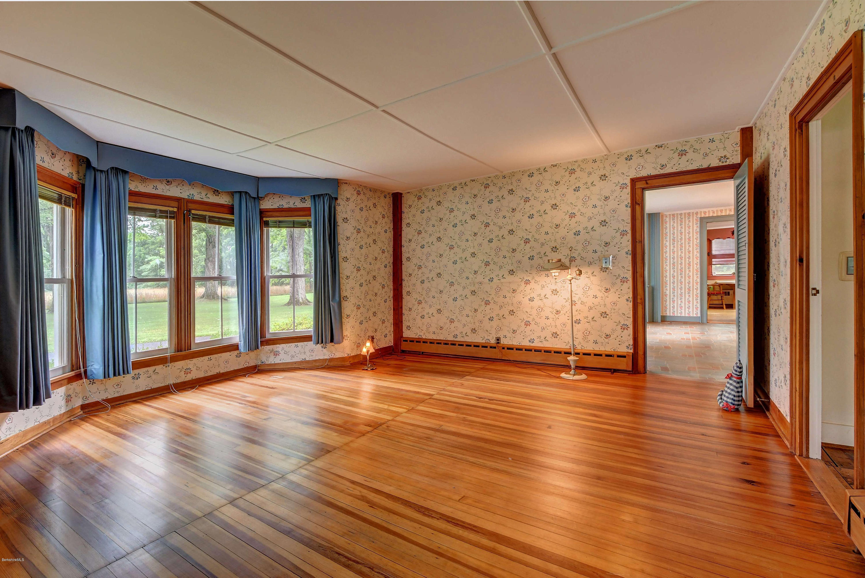 1114 Ashley Falls Road Sheffield, MA 01222 - Photo 8 of 53 a view of an empty room with wooden floor and a window