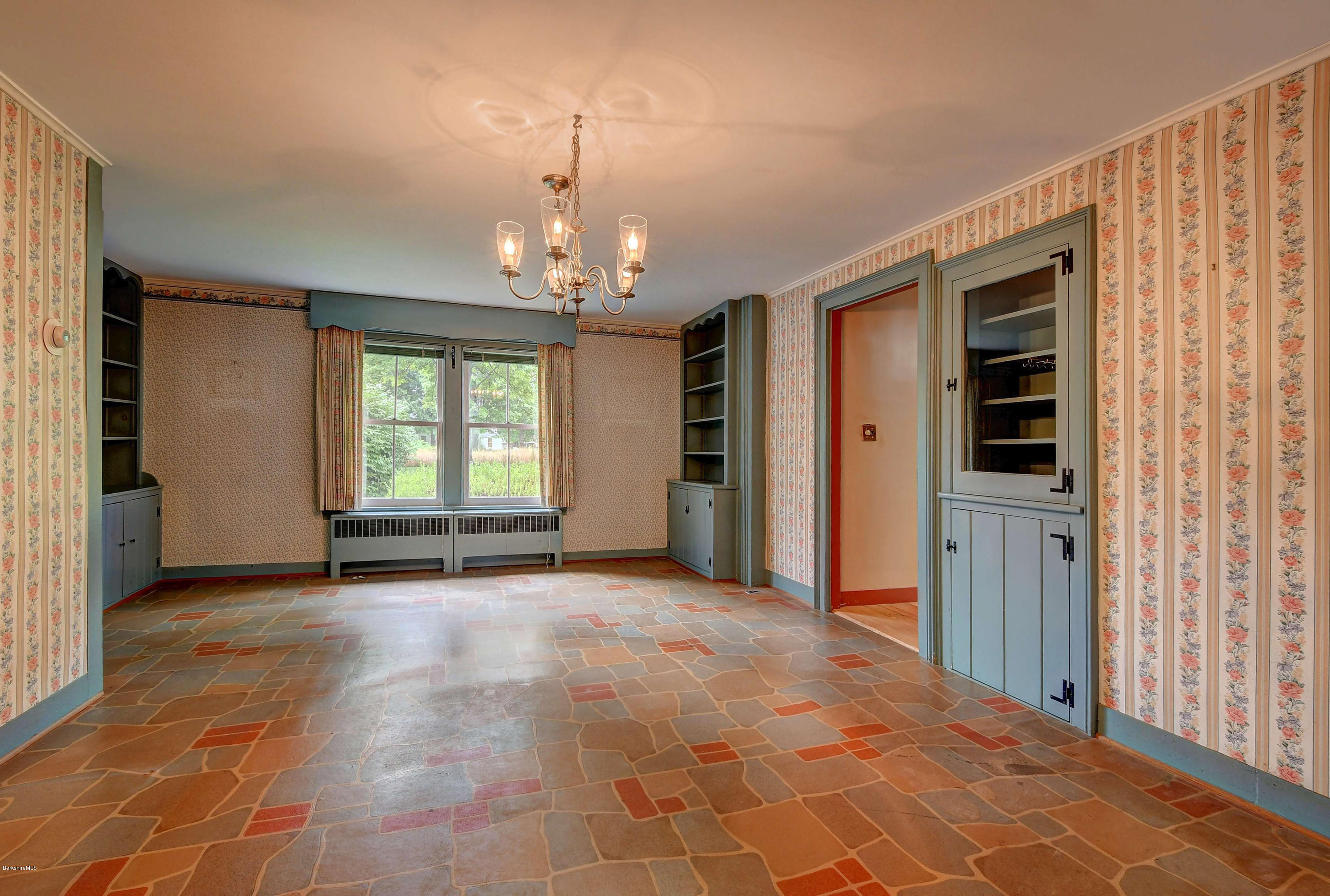 1114 Ashley Falls Road Sheffield, MA 01222 - Photo 9 of 53 an empty room with chandelier and windows