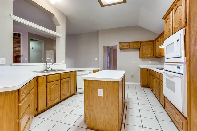 a kitchen with stainless steel appliances granite countertop a sink counter space and cabinets