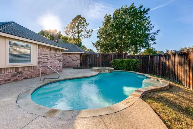 a view of a backyard with swimming pool