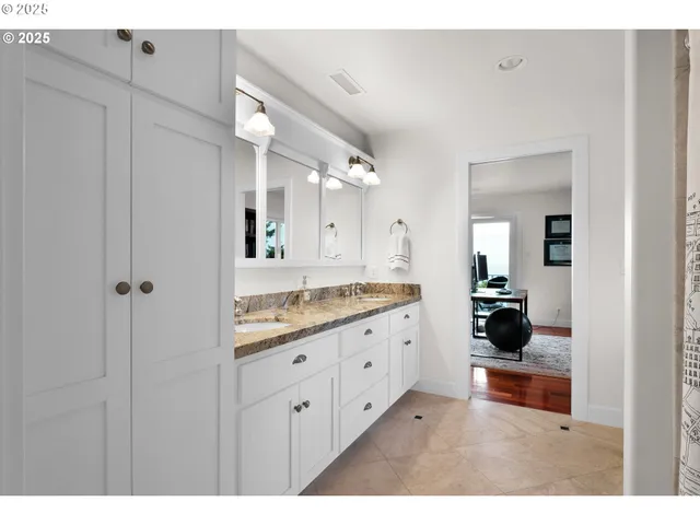 a bathroom with a granite countertop sink mirror and double